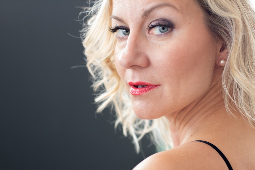 Confident woman in her 50s with natural, well-supported facial features representing the ideal candidate for Sculptra and biostimulator treatments