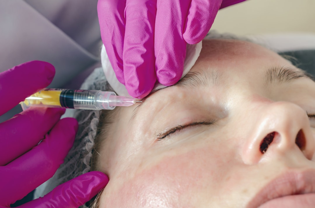 Woman receiving facial microinjections around the eye area for mesotherapy treatment. Photo by Unsplash.