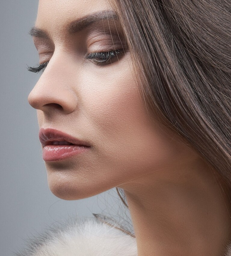 a woman with long hair and a fur collar
